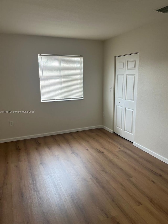 empty room featuring hardwood / wood-style flooring