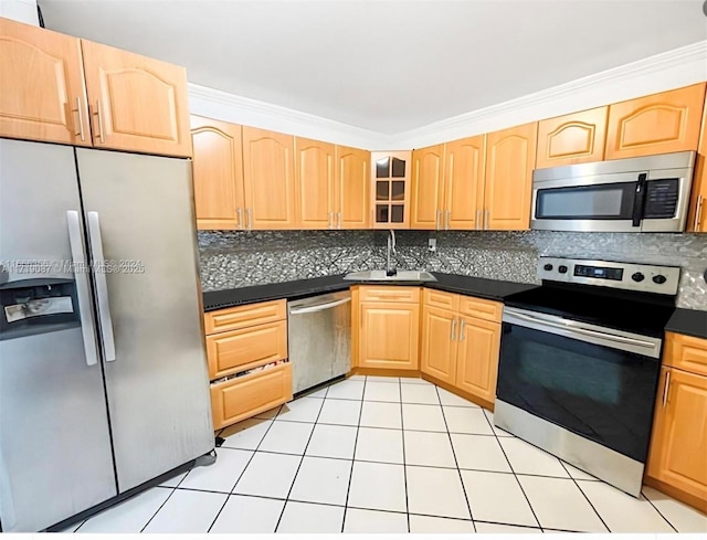 kitchen featuring appliances with stainless steel finishes, tasteful backsplash, light tile patterned floors, and sink