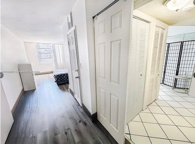 corridor with light hardwood / wood-style floors