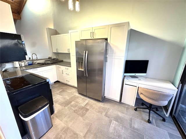 kitchen with a high ceiling, stainless steel refrigerator with ice dispenser, white cabinetry, sink, and wooden ceiling