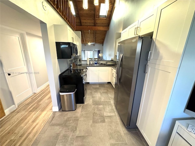 kitchen with white cabinets, stainless steel appliances, high vaulted ceiling, wooden ceiling, and beam ceiling