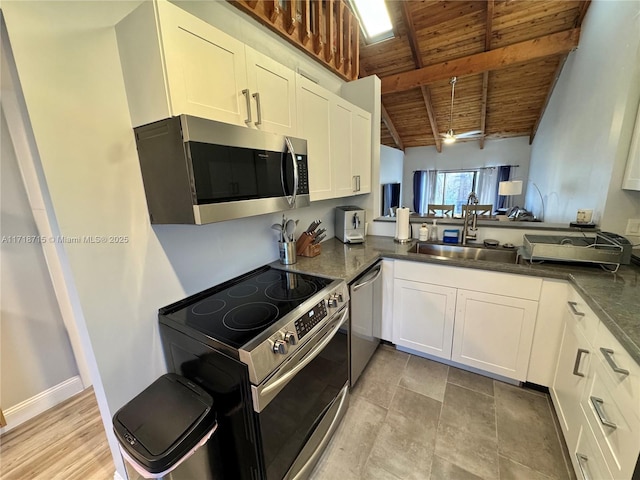 kitchen featuring kitchen peninsula, wooden ceiling, stainless steel appliances, white cabinets, and lofted ceiling with beams