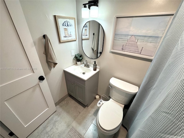 bathroom featuring toilet, vanity, and a shower with curtain