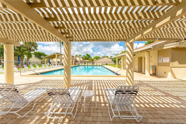 view of pool with a pergola and a patio