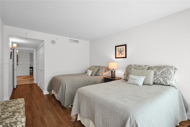 bedroom with dark hardwood / wood-style flooring