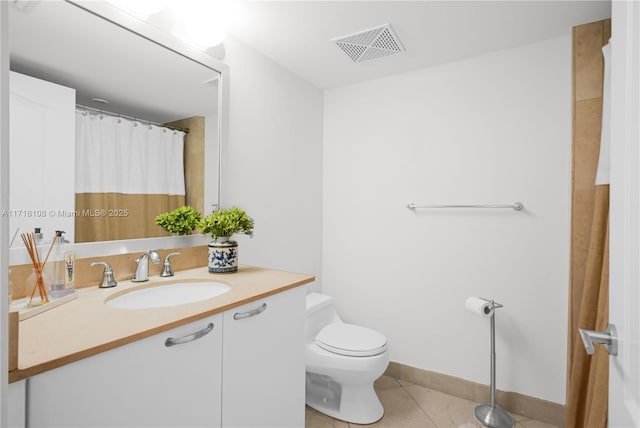 bathroom with tile patterned floors, vanity, and toilet