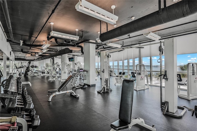 gym with a wall of windows