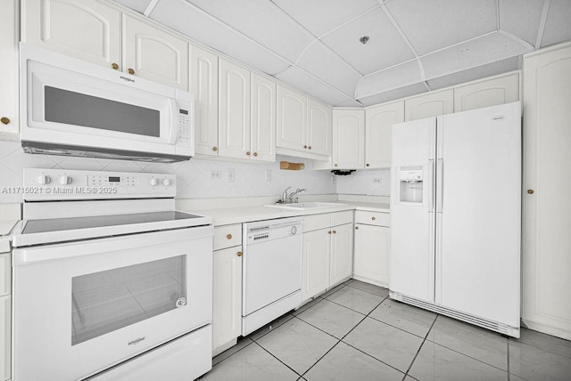 kitchen featuring white cabinets, white appliances, sink, and light tile patterned floors