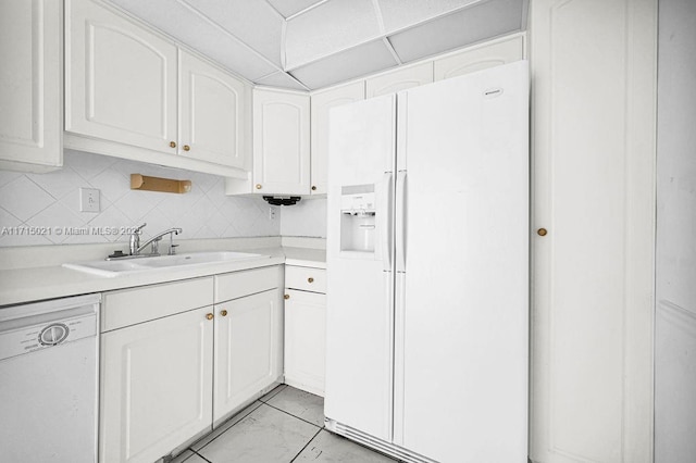 kitchen with white cabinetry, sink, and white appliances