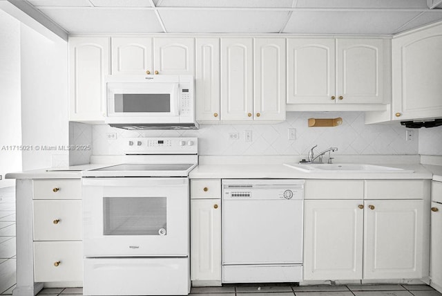 kitchen with white cabinetry, sink, tasteful backsplash, tile patterned floors, and white appliances