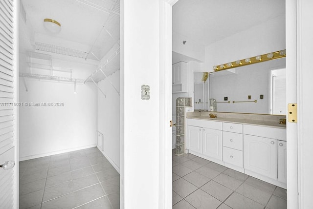 bathroom with tile patterned floors and vanity