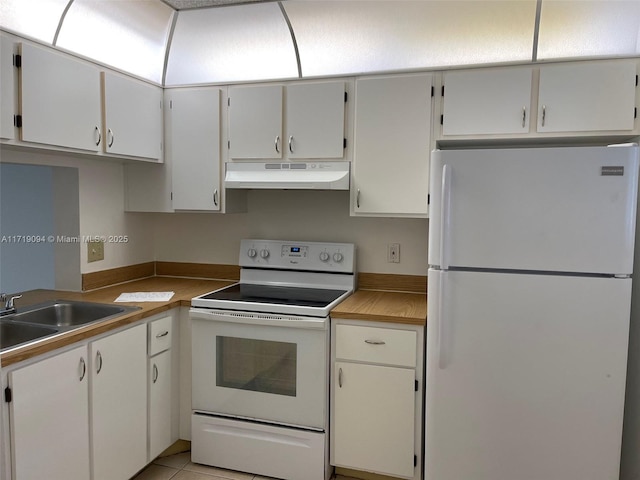 kitchen with white cabinets, white appliances, sink, and light tile patterned floors