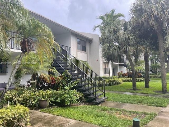 view of property exterior with a lawn