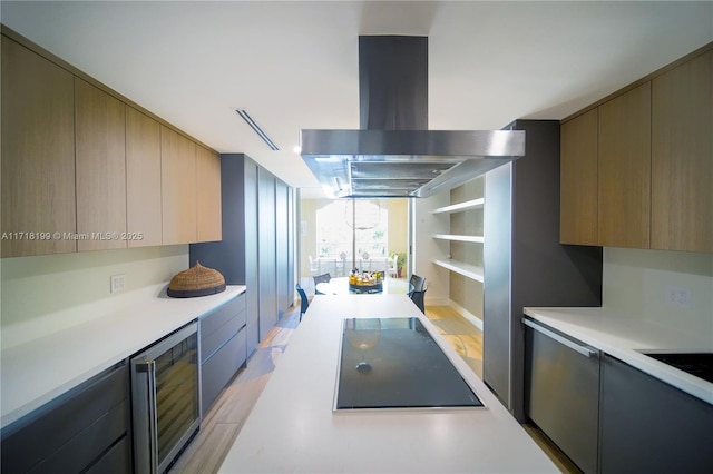 kitchen with black electric stovetop, island range hood, and wine cooler