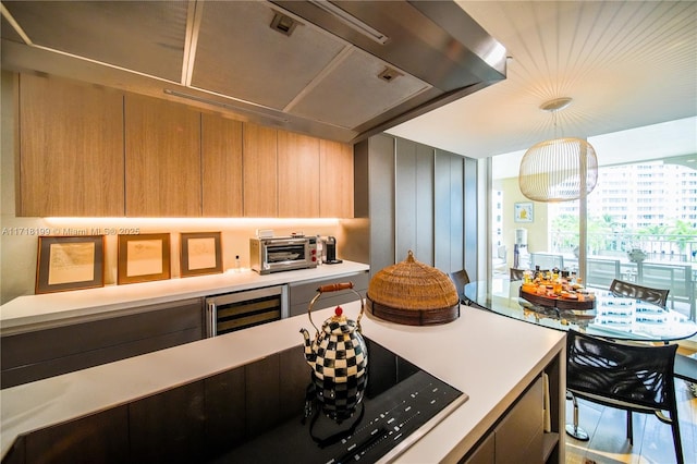 kitchen with hanging light fixtures and beverage cooler