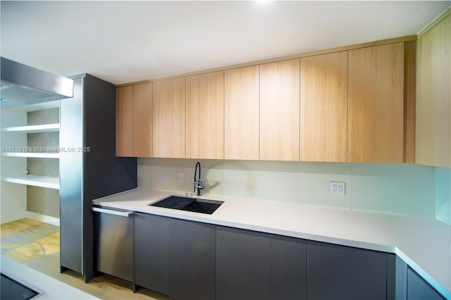 kitchen featuring sink, light brown cabinetry, and light hardwood / wood-style flooring