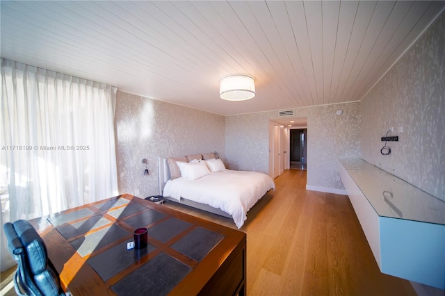 bedroom featuring wooden ceiling and light hardwood / wood-style floors