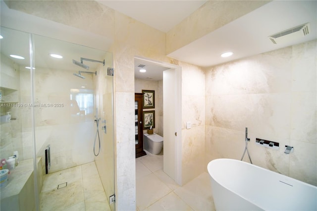 bathroom featuring tile patterned flooring, shower with separate bathtub, and tile walls