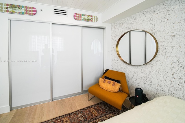 bedroom featuring dark wood-type flooring and a closet