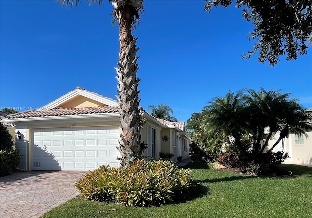 view of side of property featuring a yard and a garage