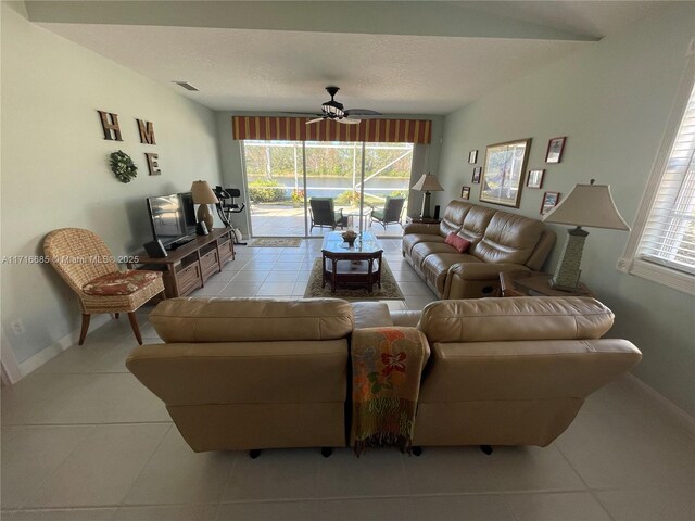 living room featuring ceiling fan and light tile patterned floors