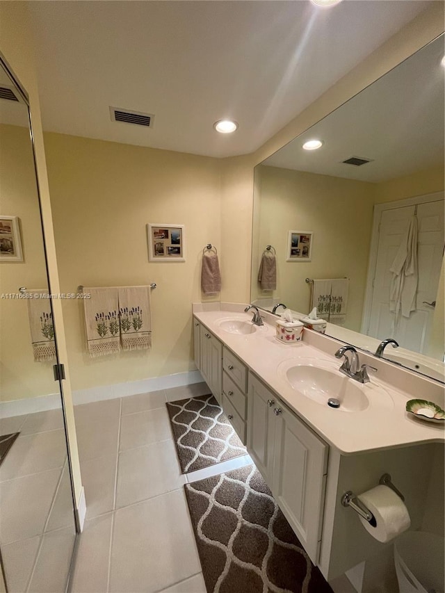 bathroom with tile patterned floors and vanity