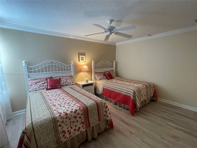 bedroom with wood-type flooring, a textured ceiling, ceiling fan, and crown molding