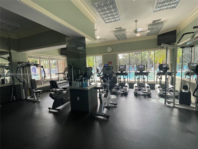 exercise room featuring ceiling fan, a healthy amount of sunlight, and ornamental molding