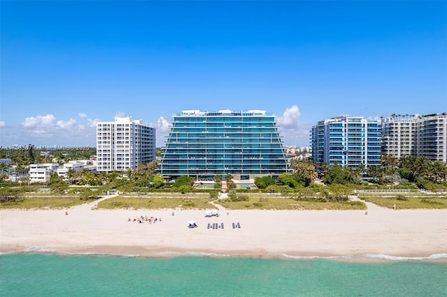 exterior space featuring a water view and a beach view