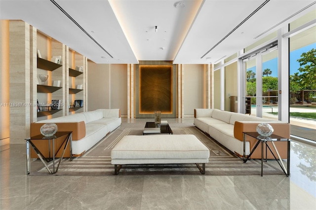 living room with a healthy amount of sunlight, a wall of windows, and french doors