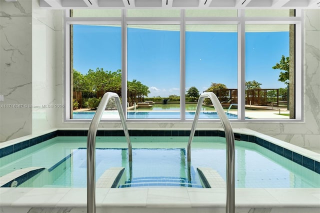 view of pool with a water view and sink