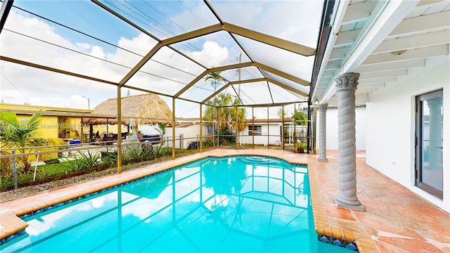 view of pool with a lanai and a patio area