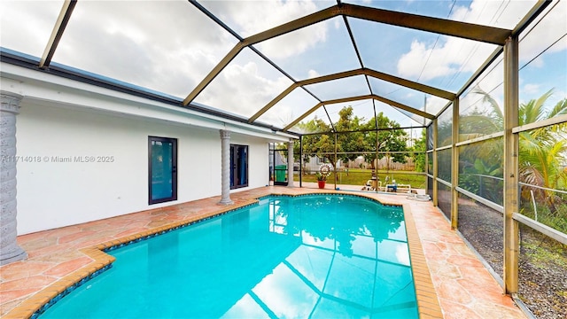 view of swimming pool with a lanai and a patio