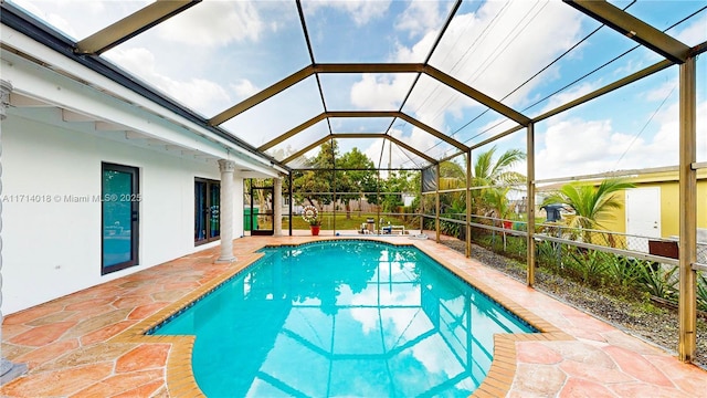 view of pool with a lanai and a patio area