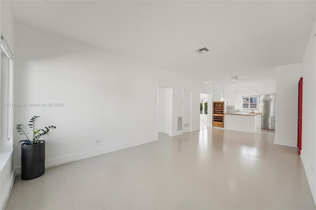 unfurnished living room featuring a wealth of natural light and light tile patterned flooring