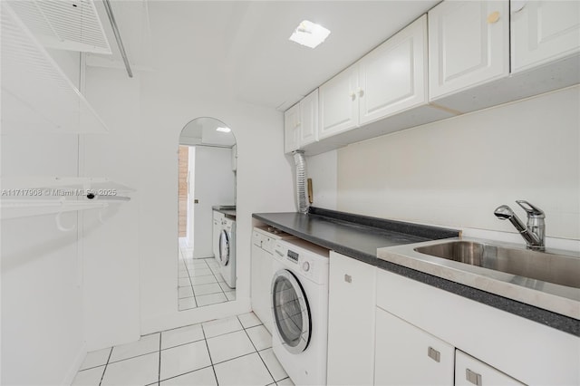 laundry room with independent washer and dryer, cabinets, light tile patterned floors, and sink