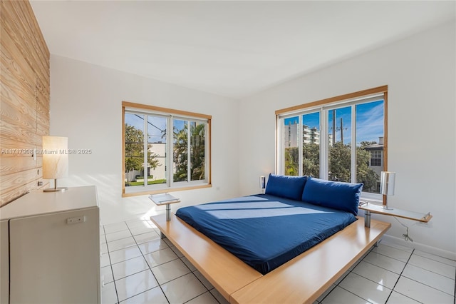 bedroom featuring multiple windows and light tile patterned floors