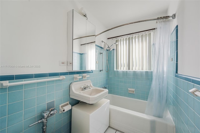 bathroom featuring tile patterned flooring, sink, tile walls, and shower / tub combo with curtain