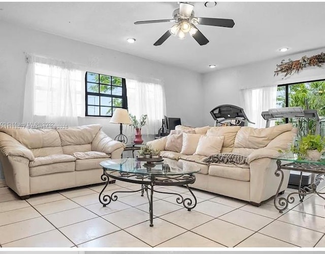 tiled living room featuring ceiling fan and a healthy amount of sunlight