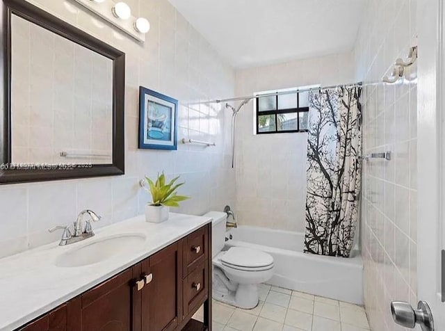 full bathroom featuring shower / bath combo, tile patterned floors, toilet, vanity, and tile walls