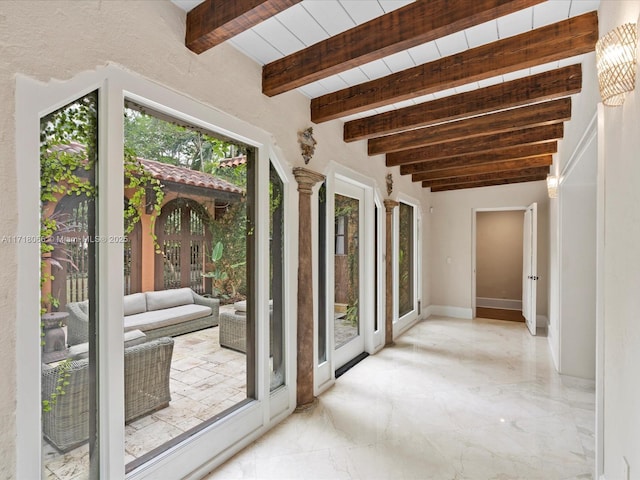 entryway featuring beamed ceiling