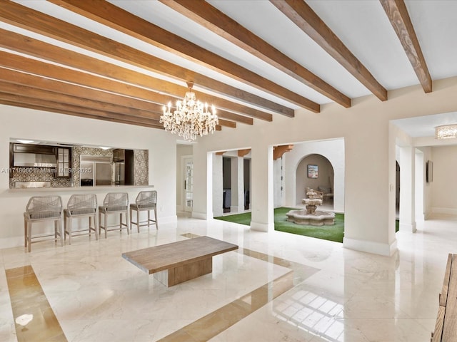 dining room featuring beamed ceiling and an inviting chandelier