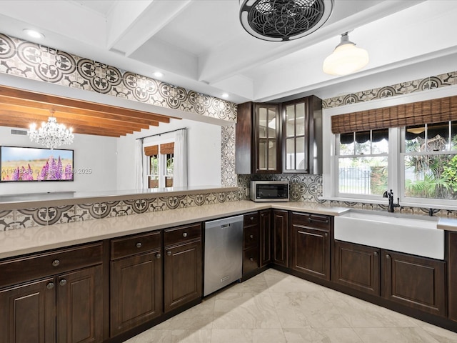 kitchen featuring sink, tasteful backsplash, a chandelier, dark brown cabinets, and stainless steel appliances