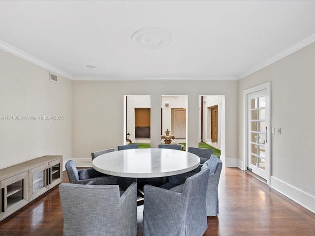 dining space featuring ornamental molding and dark wood-type flooring