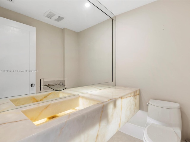 bathroom featuring vanity, toilet, and tile patterned flooring