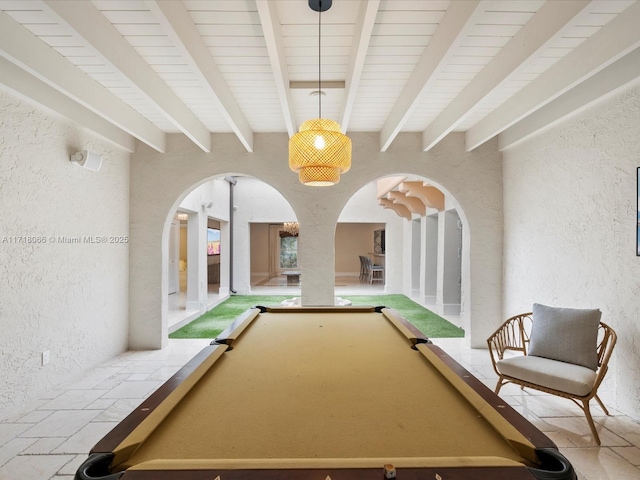 rec room with pool table and beam ceiling