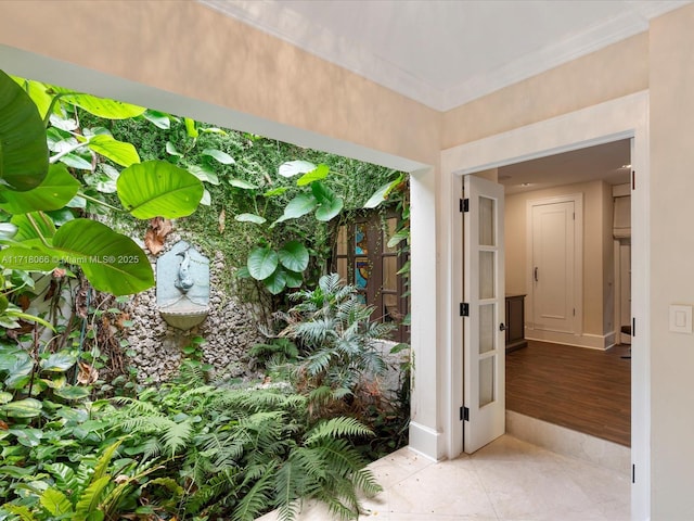 interior space with tile patterned flooring and crown molding