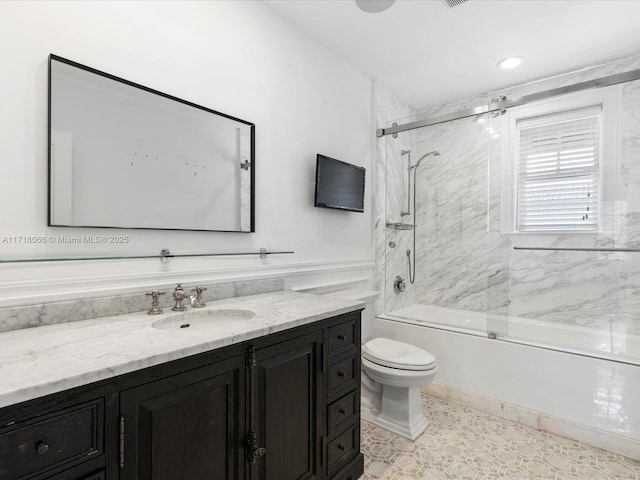 full bathroom with vanity, tile patterned floors, shower / bath combination with glass door, and toilet