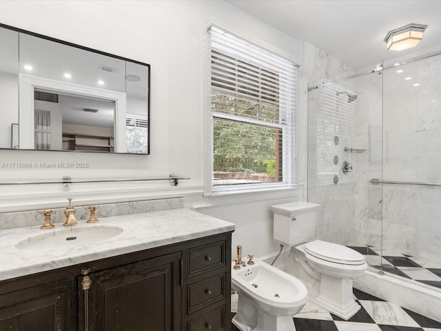 bathroom with a bidet, an enclosed shower, vanity, and toilet