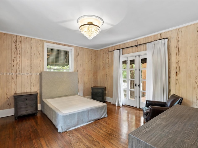 bedroom featuring dark wood-type flooring, an inviting chandelier, and access to outside